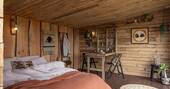 Open plan interior with indoor dining table and king size bed