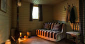 Cosy living area with log burner and soft lighting inside Deer Wood cabin at Jollydays in Yorkshire