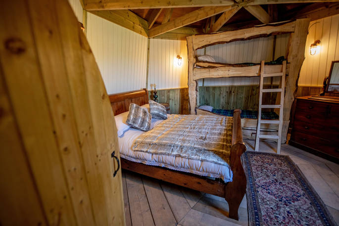 Double bed and set of bunk beds inside Ground Keeper's Cottage in Yorkshire 