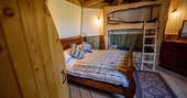 Double bed and set of bunk beds inside Ground Keeper's Cottage in Yorkshire 