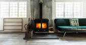 Cuddle up next to the cosy logburner at Atkinson Grimshaw cabin, North Star Club