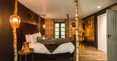 The beautifully cosy master bedroom at Star Suite, with kingsize bed and soft lighting
