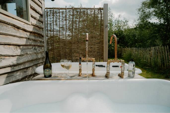 Tap running into outdoor bath