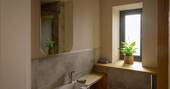 Bathroom with a hot shower, sink and flushing toilet