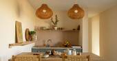 Kichen equipped with a single gas hob and cooking utensils, crockery and glassware