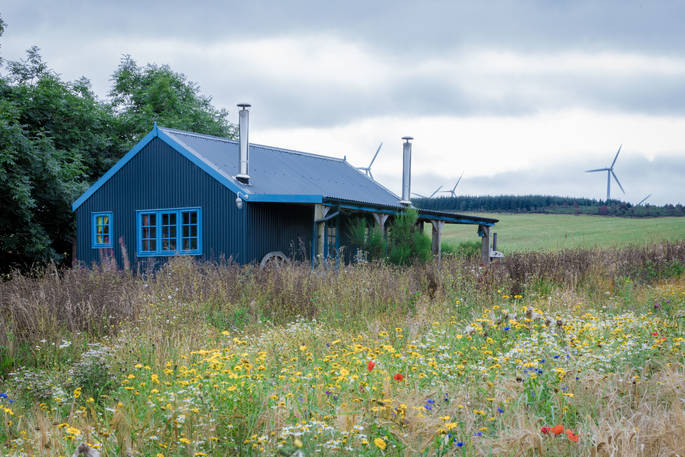 Barley Bothy exterior with wild flowers, Boutique Farm Bothies at Huntly, Aberdeenshire