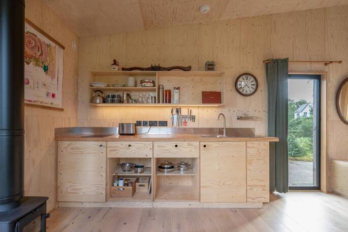 Kitchen equipped with a dual gas hob, kettle, toaster and small fridge