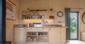 Kitchen equipped with a dual gas hob, kettle, toaster and small fridge