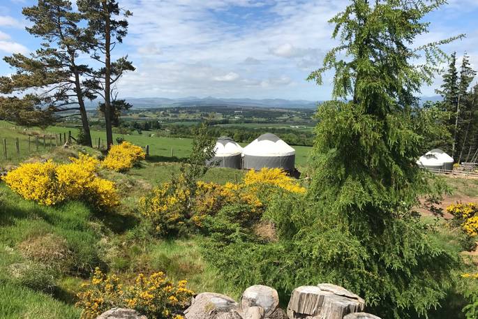 view towards heather and bramble yurt with beautiful hills in the distance