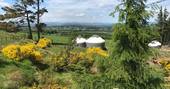 view towards heather and bramble yurt with beautiful hills in the distance