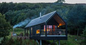 Bothan Dubh cabin at night with smoke from hot tub, Perthshire, Perth & Kinross, Scotland
