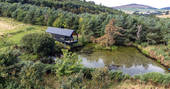 Bothan Dubh cabin at the pond, drone view, Perthshire, Perth & Kinross, Scotland