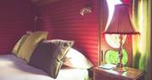 The comfortable and cosy double bed inside Gitana roulotte at Roulotte Retreat in Scotland