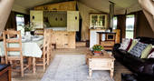 Interior of the Onnen Lodge with cabin bed and dining table in Angelsey, Wales
