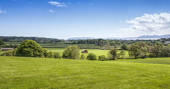 A view across the rolling green fields at Wonderfully Wild in Anglesey, Wales