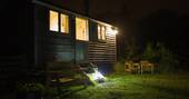 Gwdihw shepherd's hut lit up at night