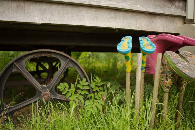 Gwdihw shepherd's hut close up of wheels and wellies in field