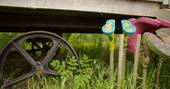 Gwdihw shepherd's hut close up of wheels and wellies in field