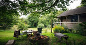 Fire pit and outdoor seating area at The Log House Studio at Cwm Farm in Carmarthenshire