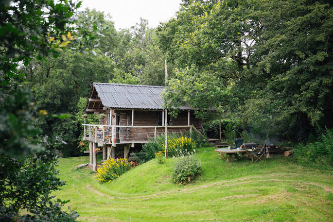 Outside seating area and side view of The log House Studio in Carmarthenshire
