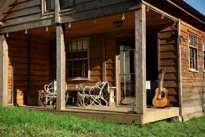 Back porch with seating for four and a firepit