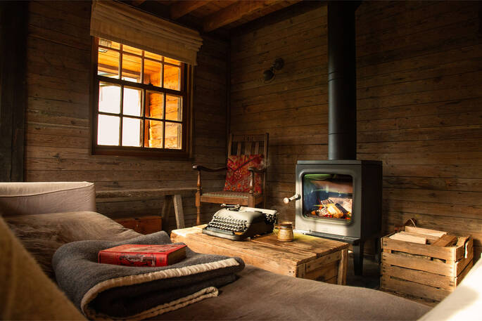 Living area with a comfortable sofa, armchairs and a wood burner