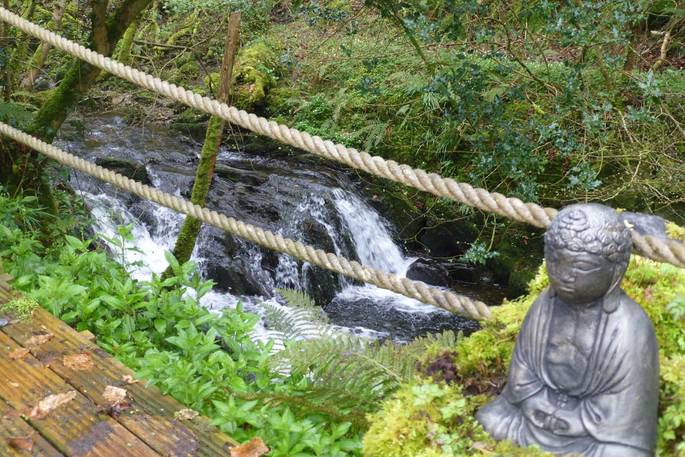 Buddha by the river at Waterfall Pagoda Yurt, Carmarthenshire