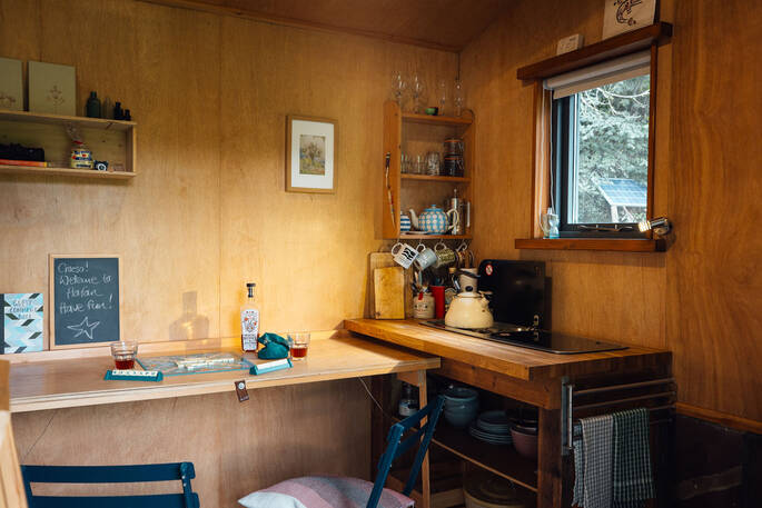 Kitchenette with fold out table and wood burner