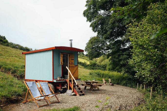 1 - front exterior showing firepit area and loungers