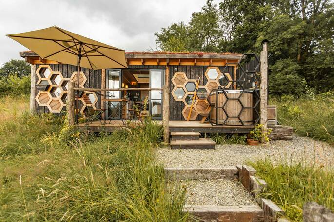 17 - front exterior showing hot tub and outdoor seating on the deck
