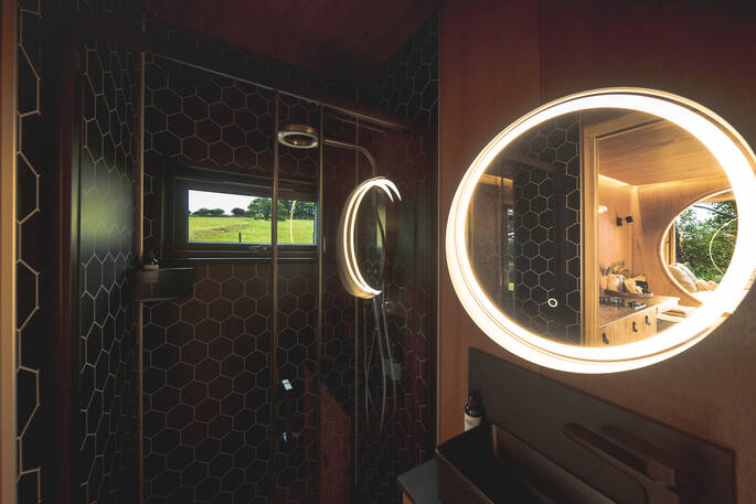 Bathroom with shower, flushing toilet and a sink