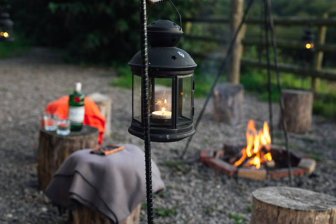 A lantern by the fire pit at One Cat Farm in Ceredigion, Wales