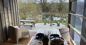 The Den cabin - view to the lake from the outdoor covered kitchen dining area, One Cat Farm, Lampeter, Ceredigion, Wales