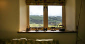 A view of the sunny hills from the window at Locke's Cottage in Wales