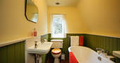 The bathroom with a large tub to relax and unwind at the end of the day at Locke's Cottage in Wales
