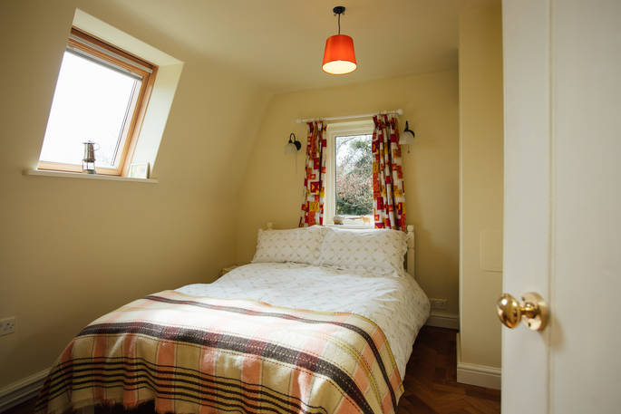 The snug bedroom where you can cosy up after a long day of walking at Locke's Cottage in Wales