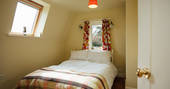 The snug bedroom where you can cosy up after a long day of walking at Locke's Cottage in Wales