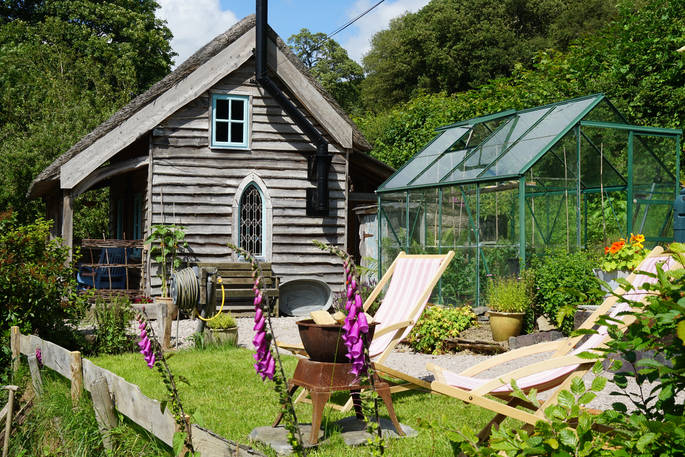 Ty Twt cabin garden with glass green house at Felin Isa, Denbigh, Conwy, Wales