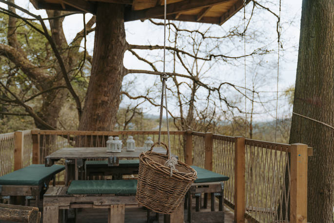 Dining area showing basket that you can hang down from the treehouse