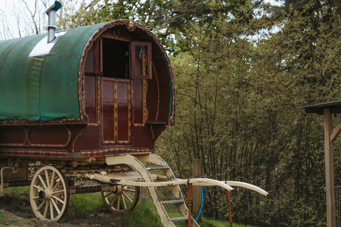 Two gypsy caravans each with a double bed inside and one with an additional wood burner