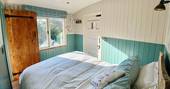 Caban Eric shepherds hut bedroom, Llygad Yr Haul, Mold, Flintshire