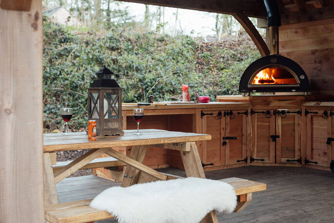 Covered outdoor kitchen with a pizza oven