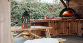 Covered outdoor kitchen with a pizza oven
