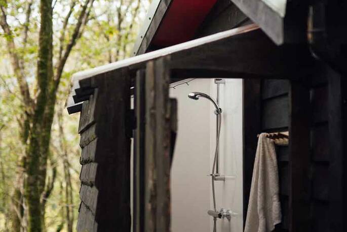 Bathroom with a hot shower, sink and flushing toilet