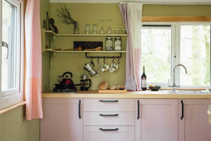 Kitchen equipped with a hob, kettle, toaster and cooking utensils