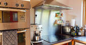 Kitchen equipped with an oven, microwave, electric hob and cooking utensils