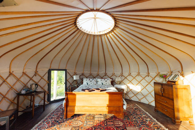 yurt with a double bed and wood burner