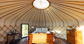 yurt with a double bed and wood burner