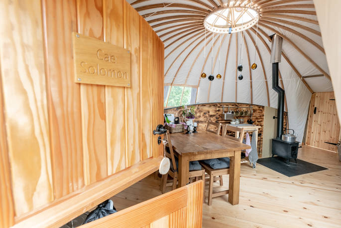 Cae Solomon at Penhein glamping alachigh tent interior with wood burner, Chepstow, Monmouthshire, Wales