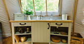Fully-equipped kitchen area inside The Cribbau tent at Penhein Glamping in Monmouthshire